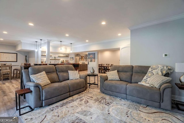 living room with light wood-type flooring and ornamental molding