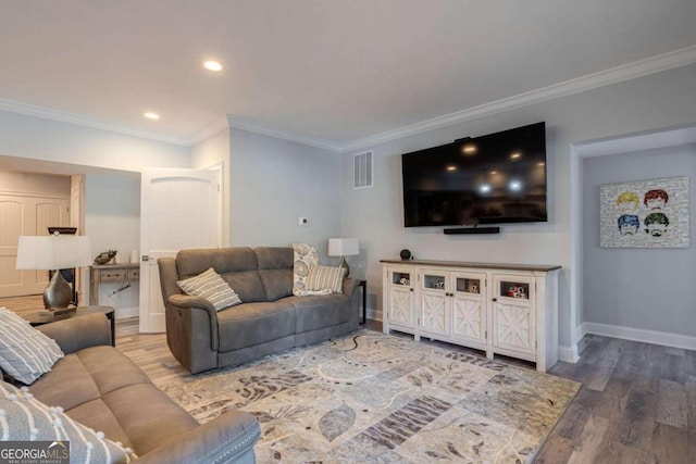 living room with hardwood / wood-style flooring and crown molding