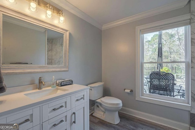 bathroom featuring crown molding, hardwood / wood-style floors, vanity, and toilet