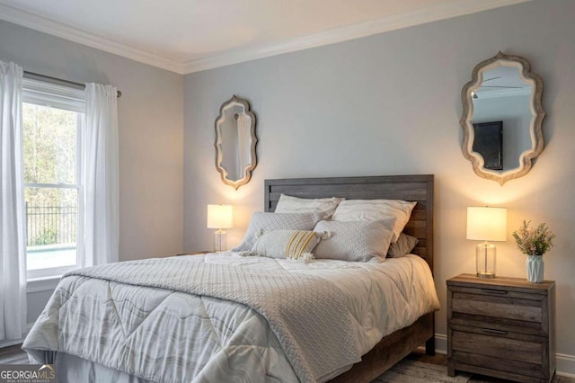 bedroom featuring wood-type flooring and crown molding