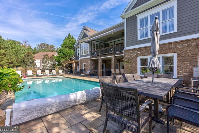 view of swimming pool with ceiling fan and a patio