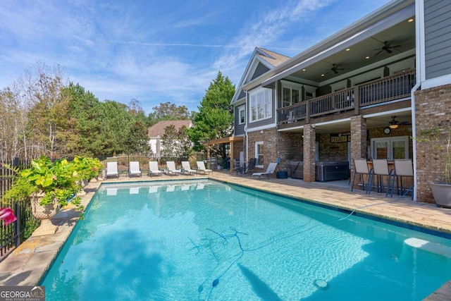 view of pool featuring ceiling fan, a patio area, and exterior bar