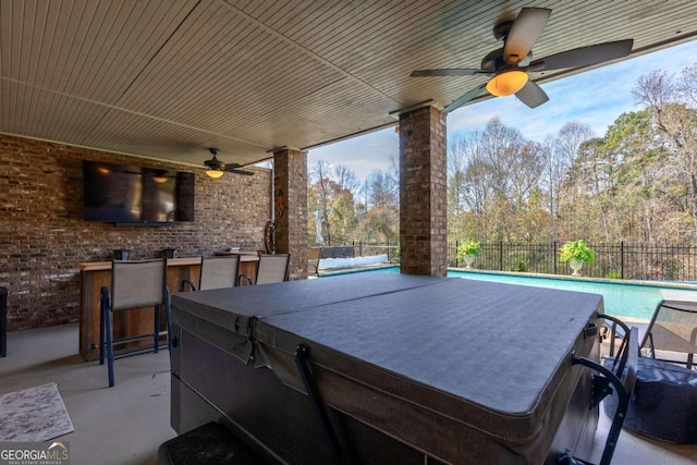 view of patio featuring a fenced in pool and exterior bar