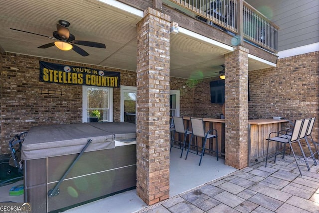 view of patio / terrace featuring exterior bar and a balcony