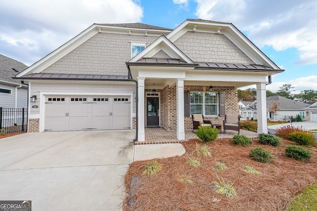 craftsman house featuring covered porch and a garage