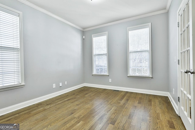 empty room featuring dark hardwood / wood-style floors and ornamental molding