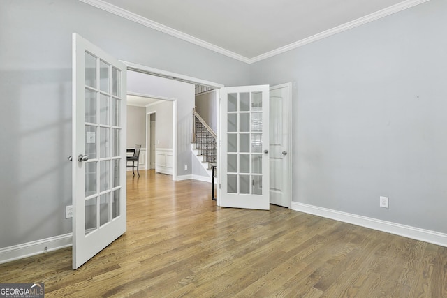 unfurnished room with wood-type flooring, ornamental molding, and french doors