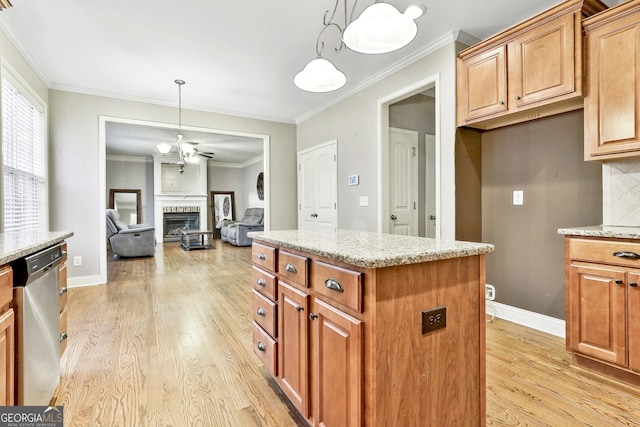 kitchen with light stone counters, pendant lighting, a center island, and stainless steel dishwasher