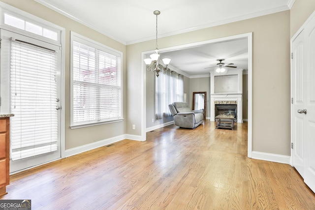 unfurnished dining area featuring crown molding and light hardwood / wood-style flooring