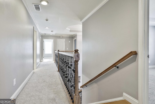 corridor with light colored carpet and ornamental molding