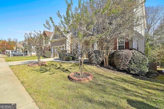 obstructed view of property with a front lawn