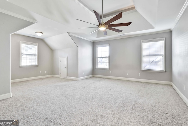 bonus room featuring light colored carpet, a wealth of natural light, and ceiling fan