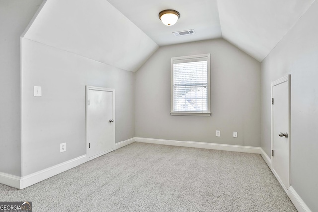 bonus room featuring light colored carpet and lofted ceiling