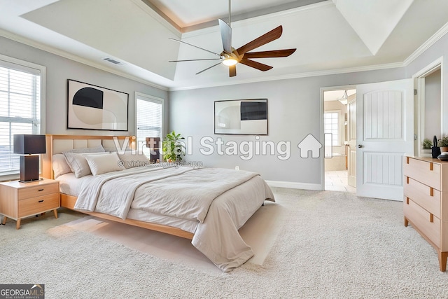 carpeted bedroom with ceiling fan, ornamental molding, and a tray ceiling