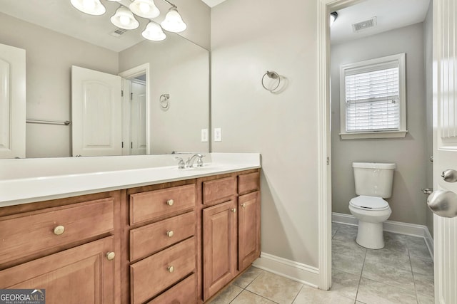 bathroom featuring tile patterned flooring, vanity, and toilet