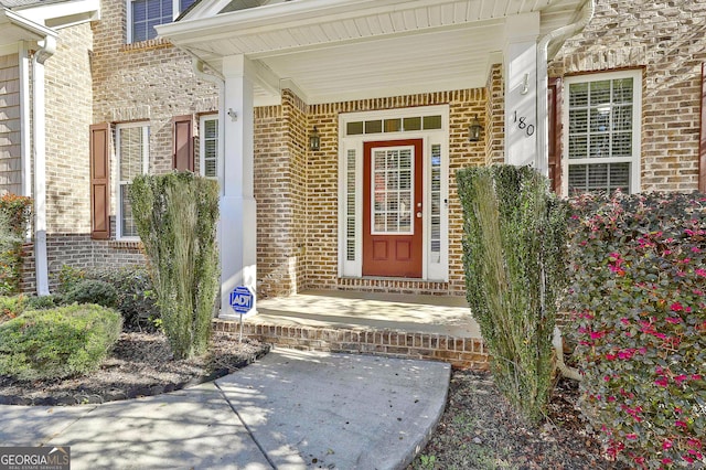 doorway to property featuring covered porch