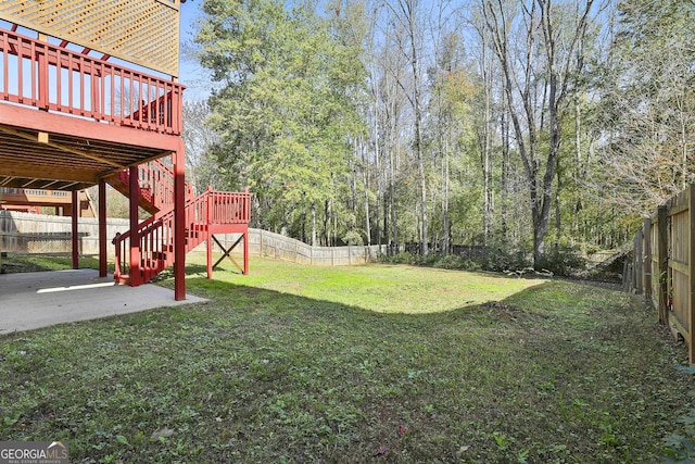 view of yard with a wooden deck and a patio area