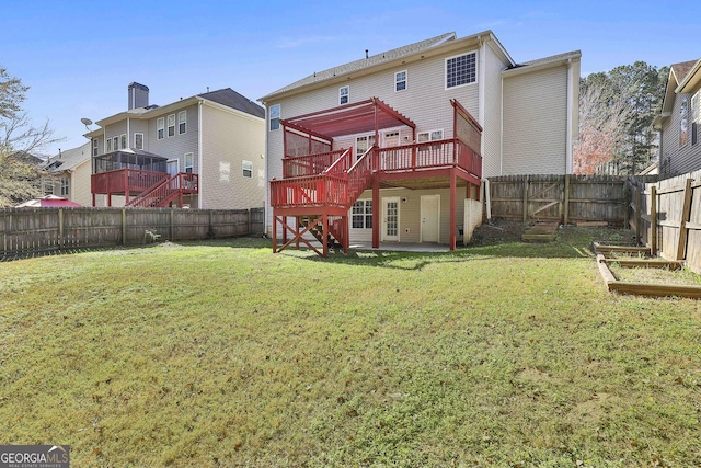 back of property featuring a wooden deck and a yard