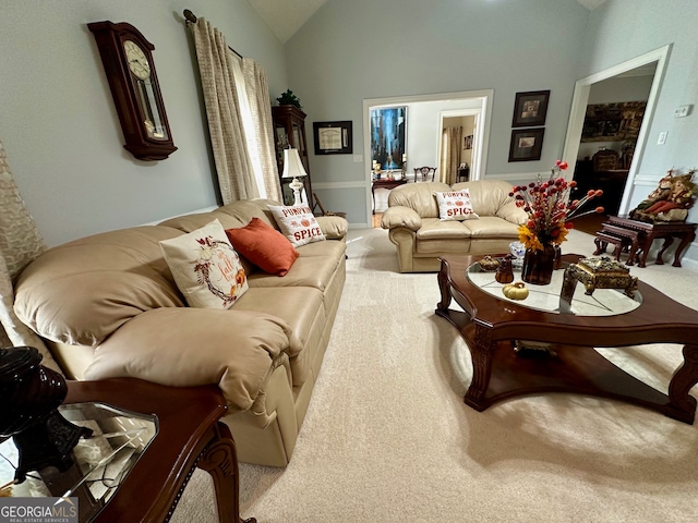 living room featuring carpet floors and vaulted ceiling