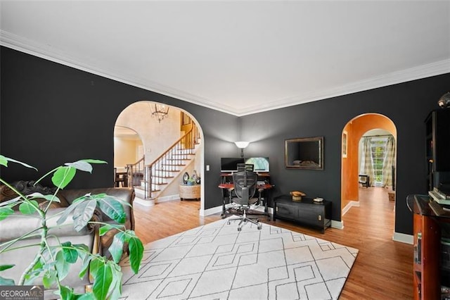 office with light wood-type flooring and crown molding