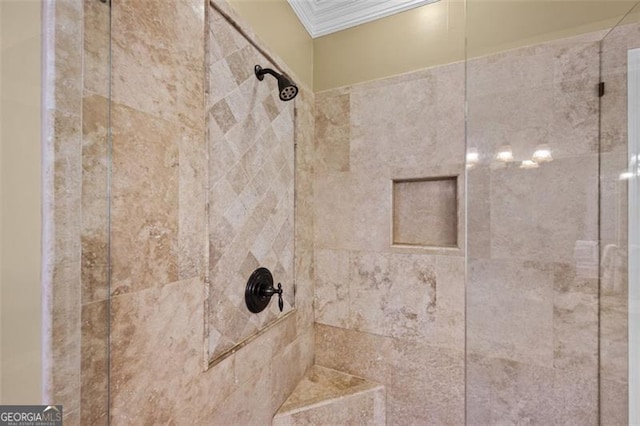 details featuring a tile shower and ornamental molding