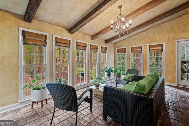 sunroom with a chandelier and beam ceiling