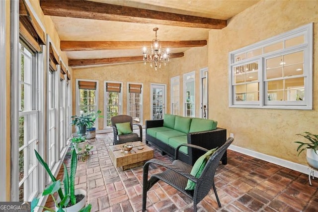 sunroom / solarium with beam ceiling, plenty of natural light, and a notable chandelier