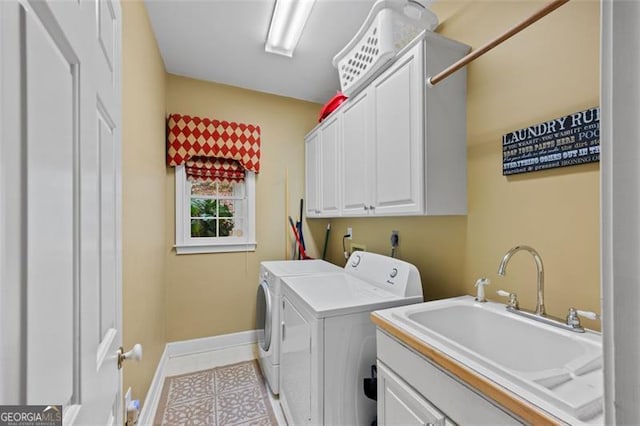 clothes washing area featuring light tile patterned flooring, cabinets, independent washer and dryer, and sink