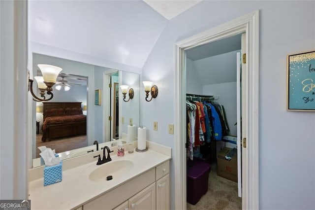 bathroom featuring ceiling fan, vanity, and lofted ceiling