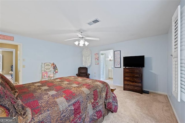 bedroom featuring light carpet, connected bathroom, and ceiling fan