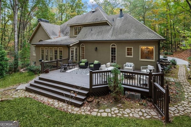 rear view of house featuring an outdoor hangout area and a wooden deck