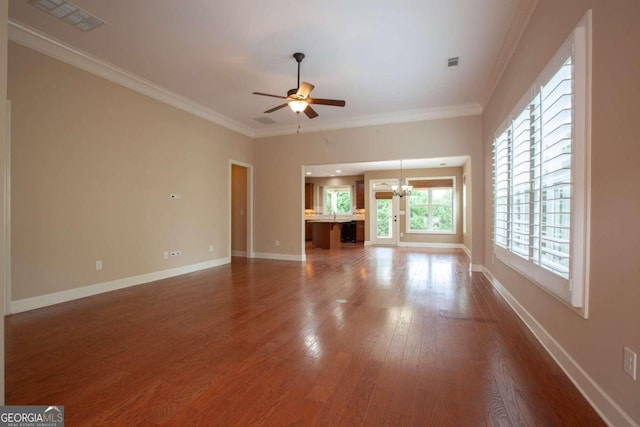 unfurnished living room with hardwood / wood-style floors, ceiling fan with notable chandelier, and ornamental molding