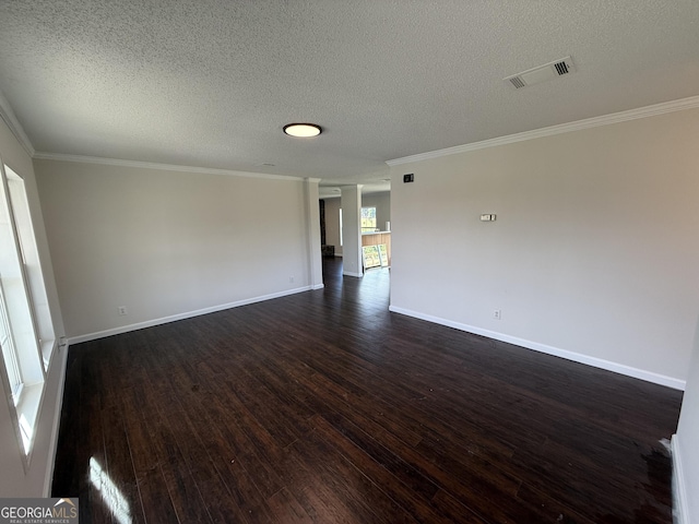 unfurnished room with a textured ceiling, crown molding, and dark wood-type flooring