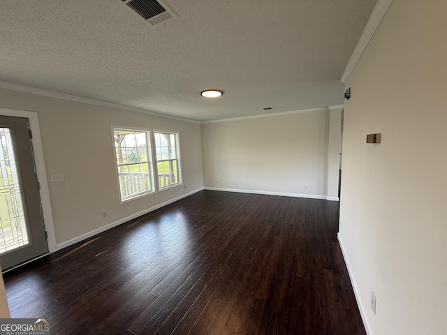 empty room with a textured ceiling, a wealth of natural light, crown molding, and dark hardwood / wood-style floors