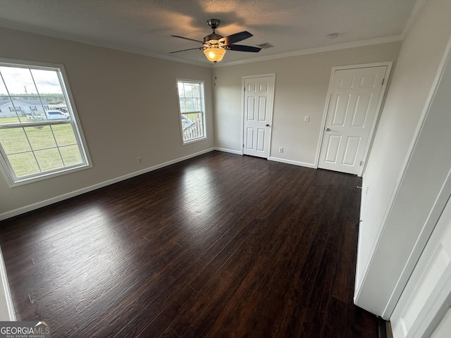 empty room featuring ceiling fan, crown molding, and dark hardwood / wood-style floors