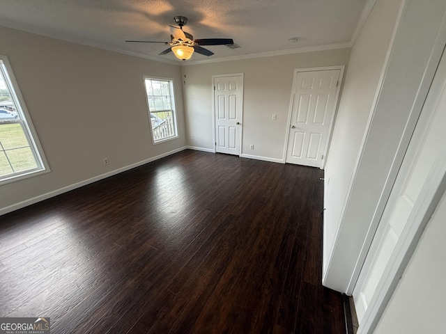 unfurnished room featuring crown molding, dark hardwood / wood-style flooring, ceiling fan, and a textured ceiling