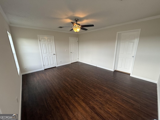 spare room with a textured ceiling, dark hardwood / wood-style floors, ceiling fan, and crown molding