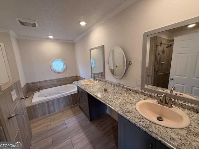 bathroom featuring vanity, a textured ceiling, plus walk in shower, and crown molding