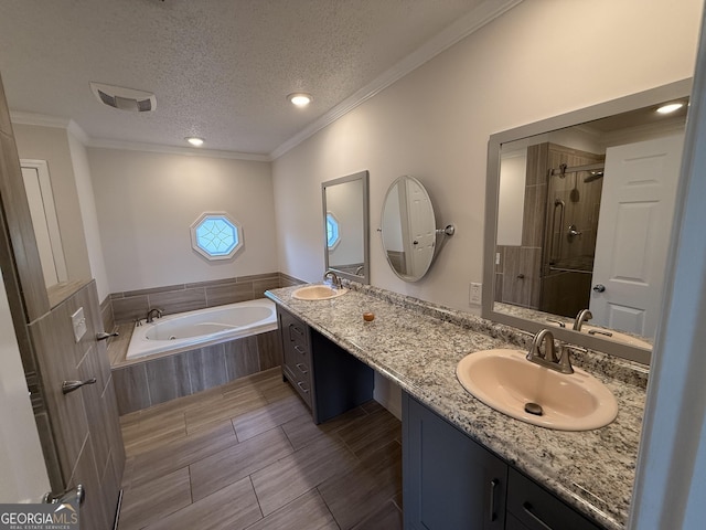 bathroom featuring vanity, shower with separate bathtub, a textured ceiling, and crown molding