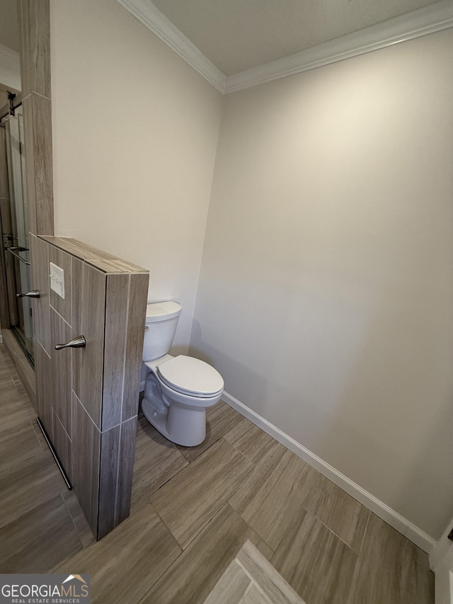 bathroom with toilet and ornamental molding