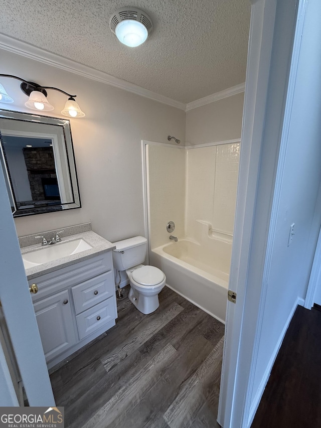 full bathroom with shower / tub combination, crown molding, toilet, a textured ceiling, and wood-type flooring