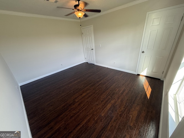 empty room featuring a textured ceiling, ceiling fan, crown molding, and dark hardwood / wood-style floors