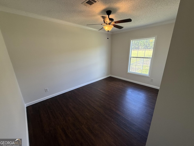 empty room featuring a textured ceiling, dark hardwood / wood-style flooring, ceiling fan, and crown molding