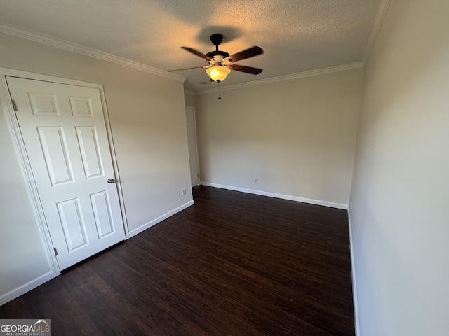 unfurnished room with dark hardwood / wood-style floors, ornamental molding, and a textured ceiling