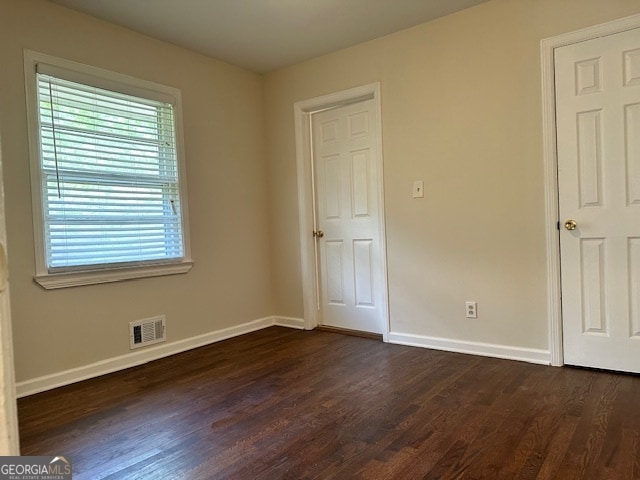 spare room with dark hardwood / wood-style flooring