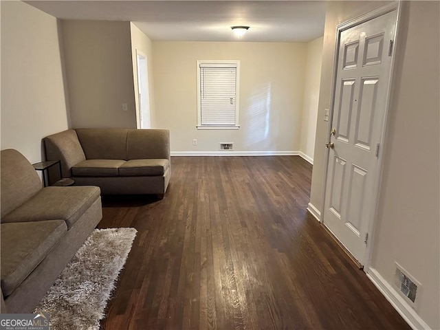 living room with dark hardwood / wood-style flooring