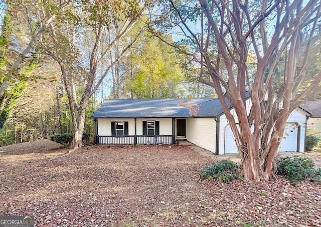 ranch-style house with a porch and a garage