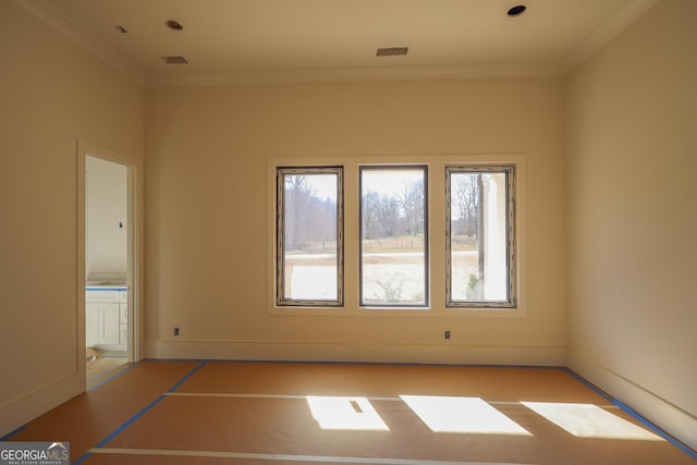 unfurnished room with baseboards and crown molding