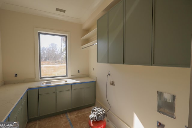 laundry room featuring cabinet space and a sink