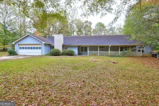 ranch-style home featuring covered porch, a garage, and a front lawn